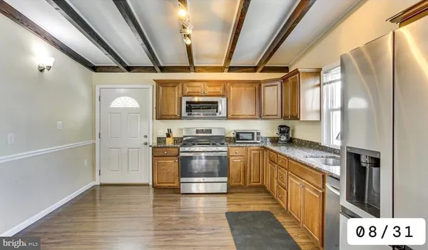 a view of a kitchen with furniture and a window