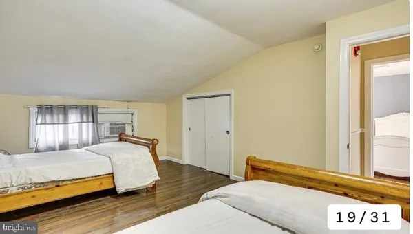 a bedroom with a bed and window