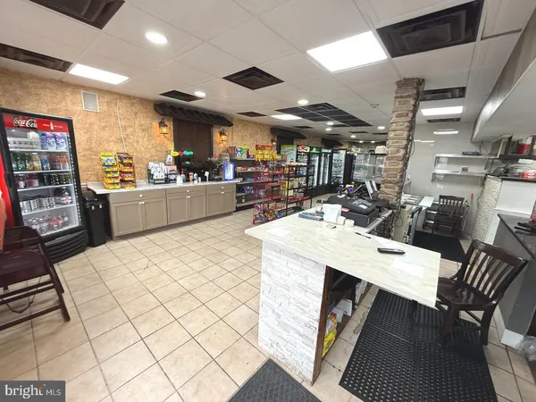 a large kitchen with lots of counter space a sink appliances and cabinets