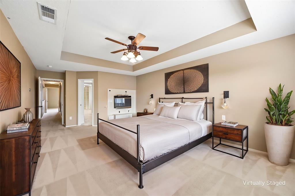 584 Pendleton Drive Rockwall, TX 75032 - Photo 12 of 28 a spacious bedroom with a bed and a chair