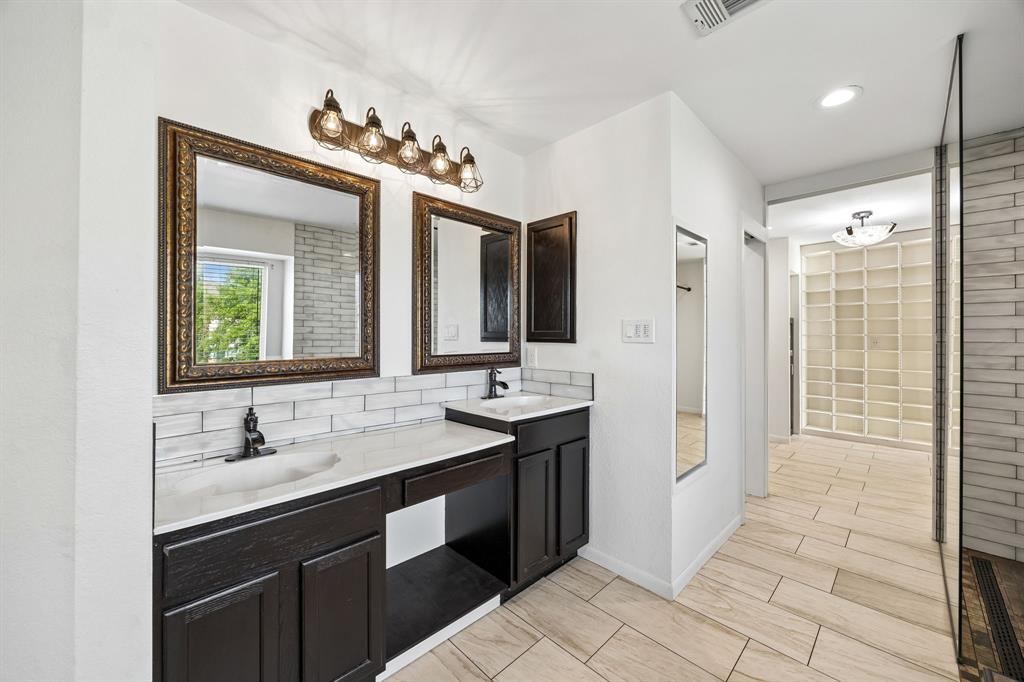 584 Pendleton Drive Rockwall, TX 75032 - Photo 14 of 28 a bathroom with a double vanity sink and mirror