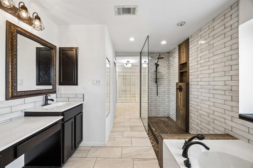 584 Pendleton Drive Rockwall, TX 75032 - Photo 15 of 28 a bathroom with a sink a toilet a mirror and shower