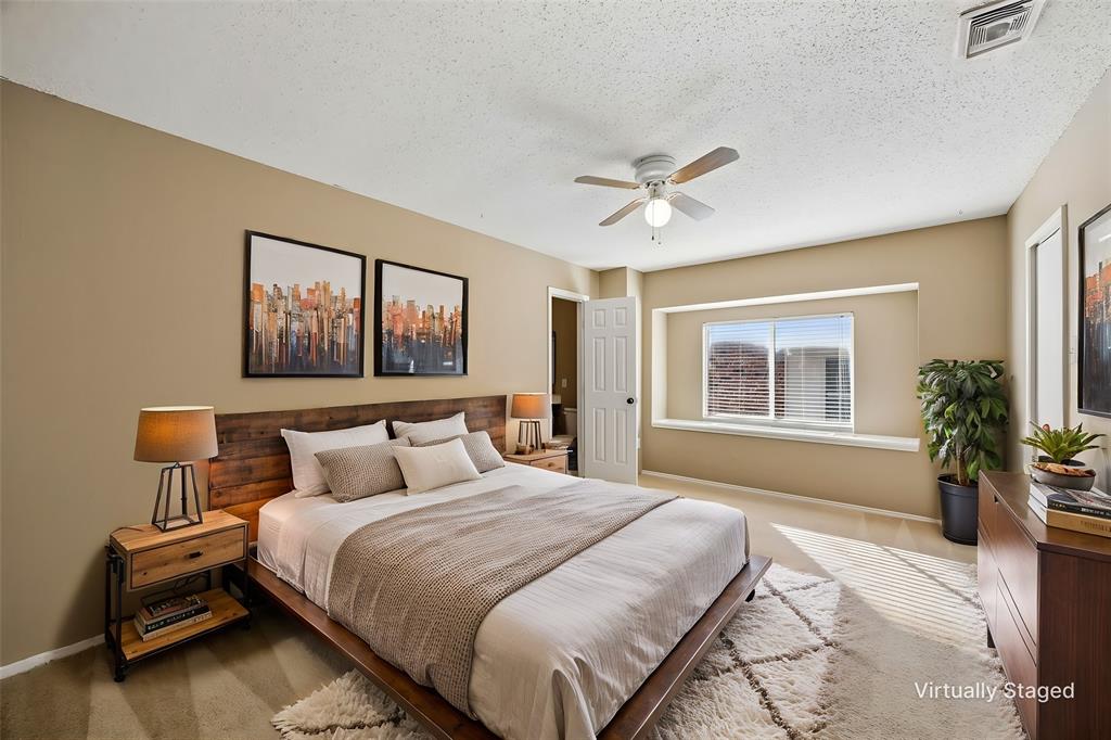 584 Pendleton Drive Rockwall, TX 75032 - Photo 19 of 28 a bedroom with a large bed and a chandelier