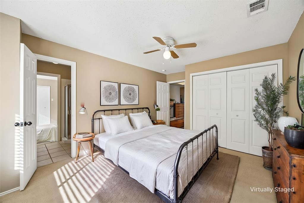 584 Pendleton Drive Rockwall, TX 75032 - Photo 20 of 28 a bedroom with a bed and a chandelier