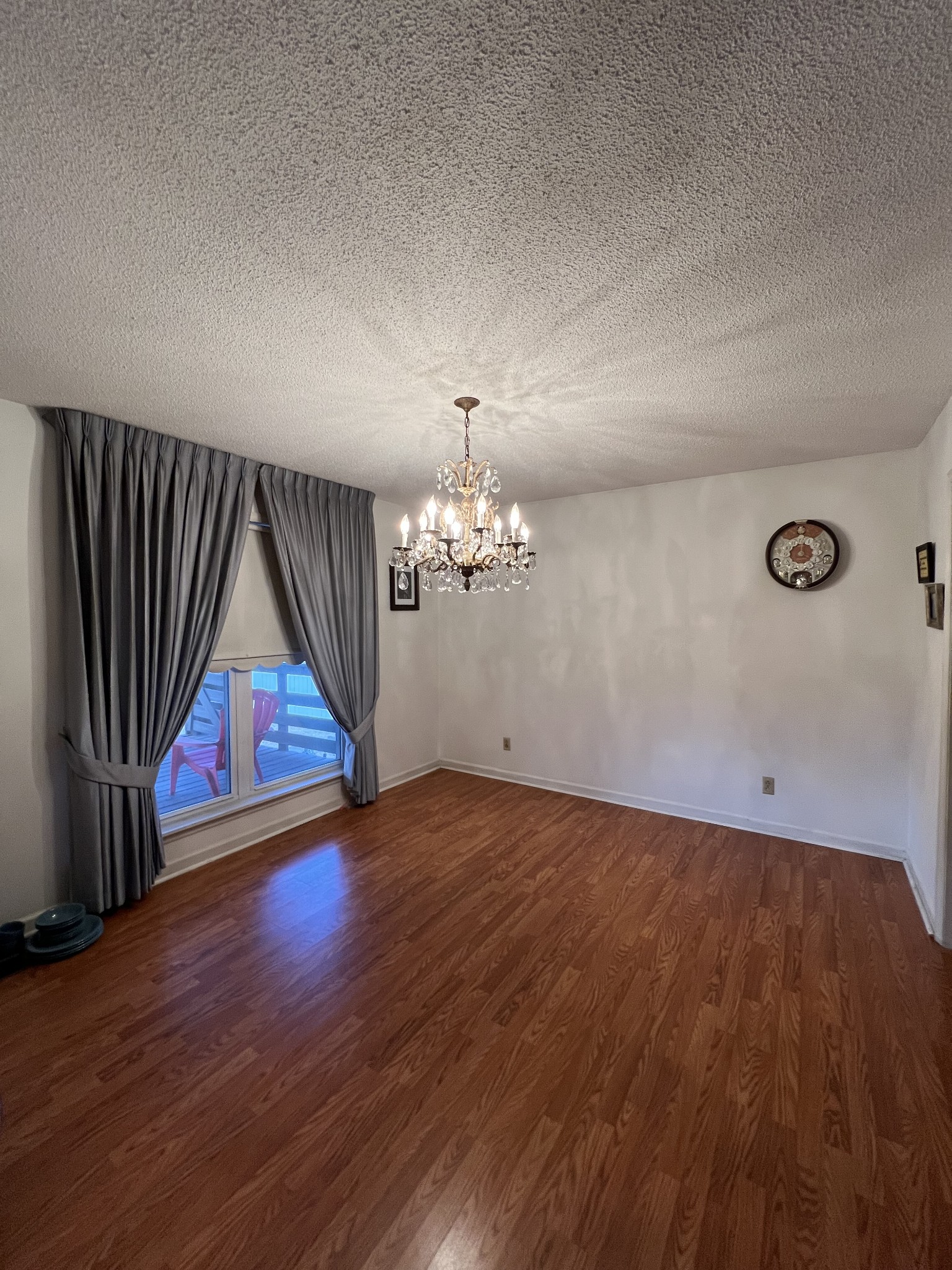 4555 Gamaliel Road Red Boiling Springs, TN 37150 - Photo 5 of 25 an empty room with wooden floor chandelier and windows
