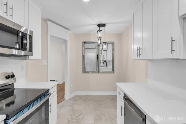 a kitchen with stainless steel appliances granite countertop a sink and a stove