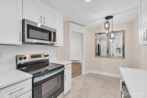 a kitchen with stainless steel appliances a stove a microwave and cabinets