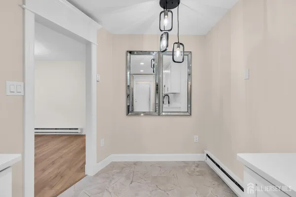 a view of empty room with wooden floor and ceiling fan