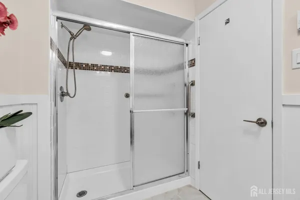 a bathroom with a glass shower door