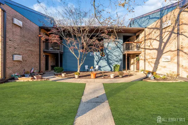 a view of a backyard with table and chairs under an umbrella