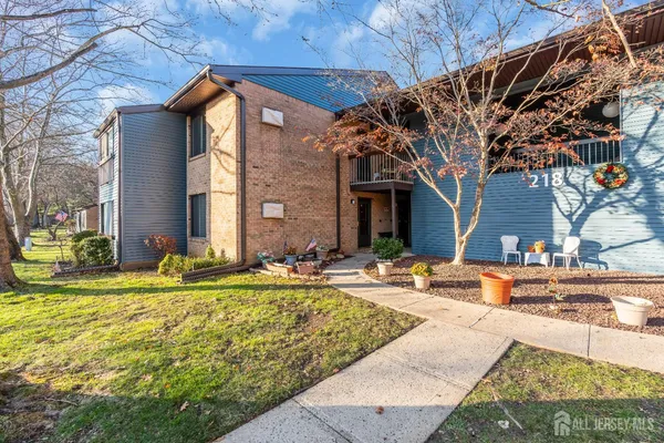 a view of a house with backyard and sitting area