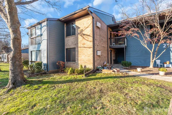 a view of house with backyard and tree
