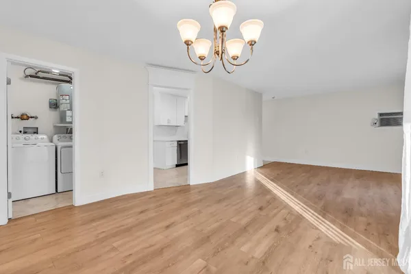 a view of a room with wooden floor and ceiling fan