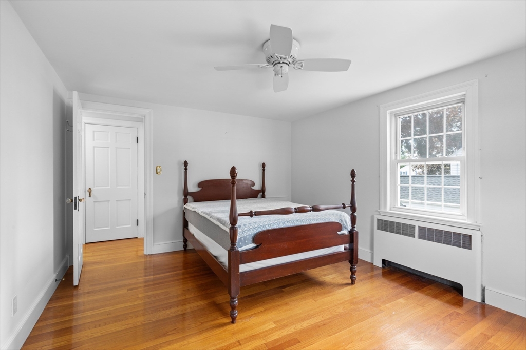 5 Sunset Road Salem, MA 01970 - Photo 15 of 32 a bedroom with a bed and wooden floor