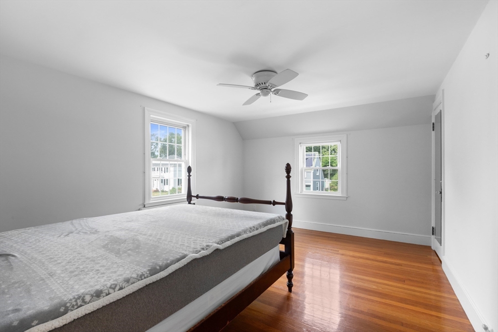 5 Sunset Road Salem, MA 01970 - Photo 16 of 32 a bedroom with a bed and wooden floor