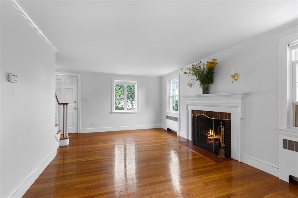 5 Sunset Road Salem, MA 01970 - Photo 4 of 32 a living room with wooden floor and a fireplace