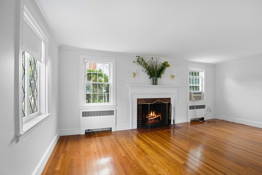5 Sunset Road Salem, MA 01970 - Photo 5 of 32 a view of an empty room with wooden floor fireplace and a window