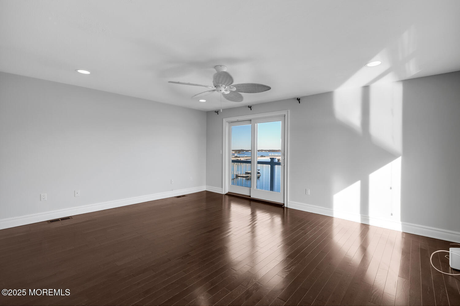 165 Riddle Avenue, Unit 7 Long Branch, NJ 07740 - Photo 30 of 87 a view of an empty room with a window and wooden floor