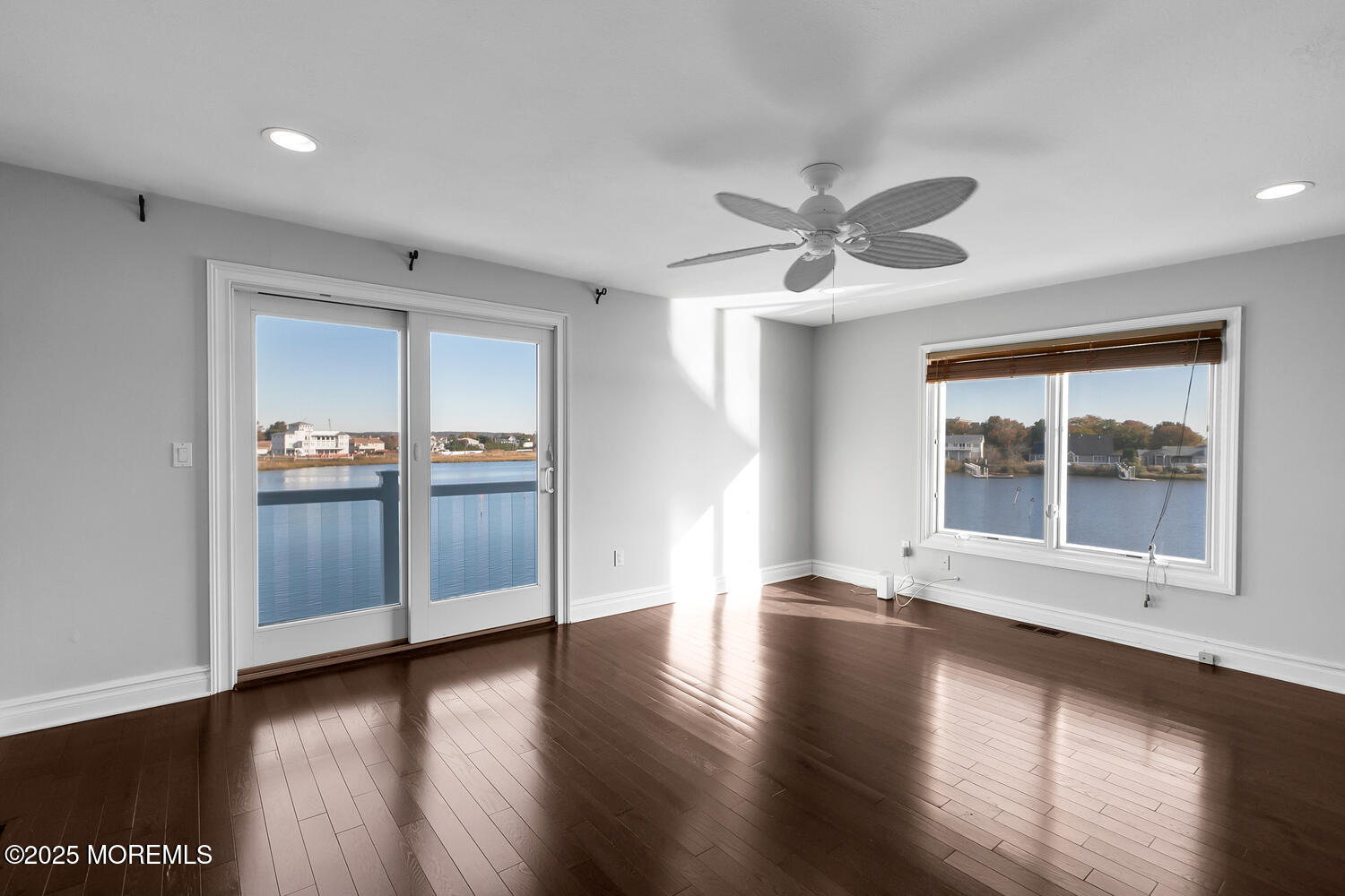 165 Riddle Avenue, Unit 7 Long Branch, NJ 07740 - Photo 31 of 87 a view of an empty room with a window and wooden floor