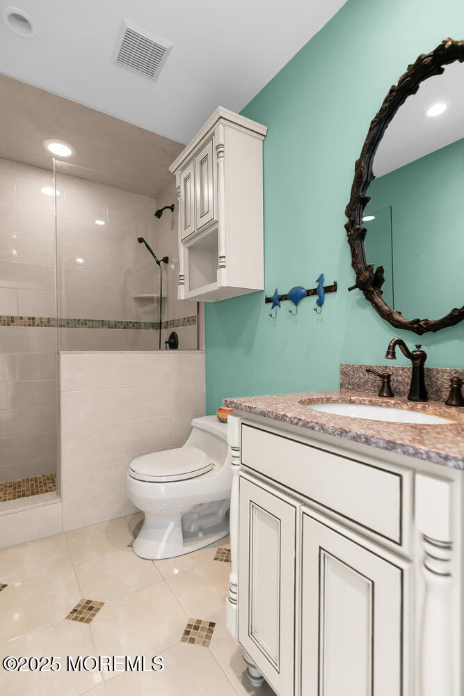 165 Riddle Avenue, Unit 7 Long Branch, NJ 07740 - Photo 38 of 87 a bathroom with a granite countertop toilet sink and mirror