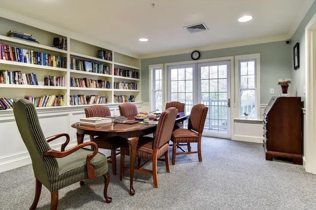 a view of a dining room with furniture and a bookshelf