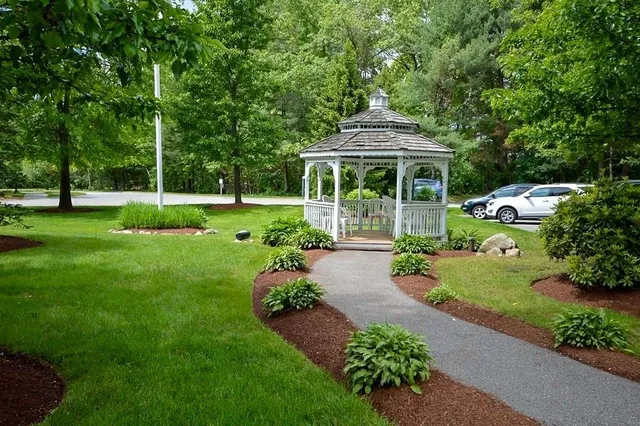a view of a garden with an outdoor seating