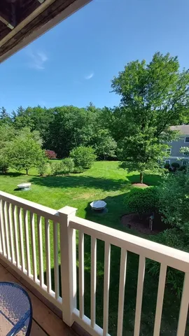 a view of a wooden deck with a yard