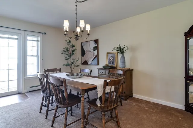 a view of a dining room with furniture and window