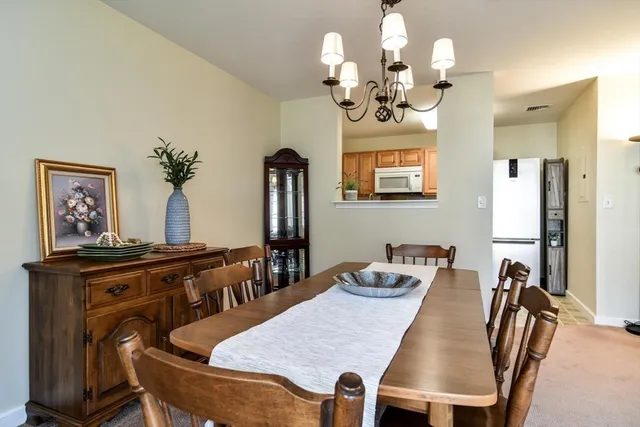 a view of a dining room with furniture and chandelier