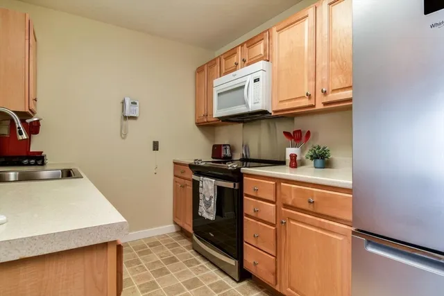 a kitchen with stainless steel appliances granite countertop a sink and a stove