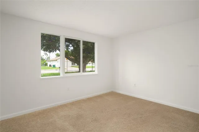 a view of wooden floor and a window in a room