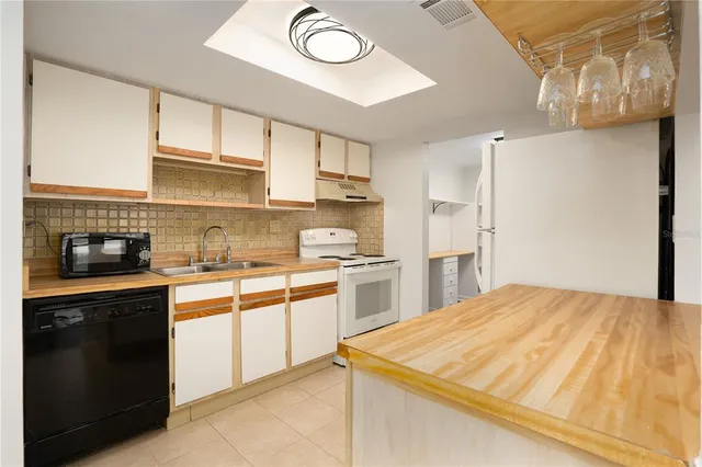 a kitchen with stainless steel appliances granite countertop a sink and cabinets