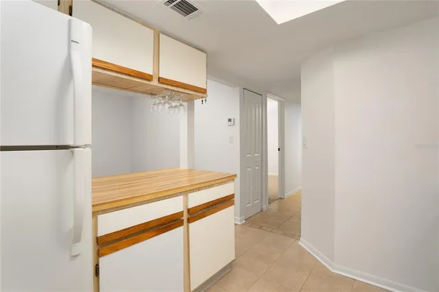 a kitchen with a stove and white cabinets