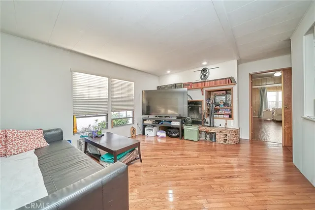 a living room with furniture large window and flat screen tv
