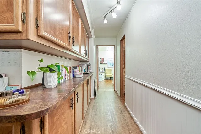 a dining room with furniture entryway and wooden floor