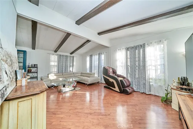 a living room with furniture stove and large windows