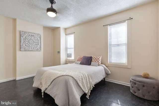 a bedroom with a bed and a window