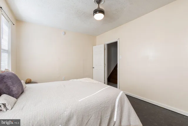 a bedroom with a bed and a window