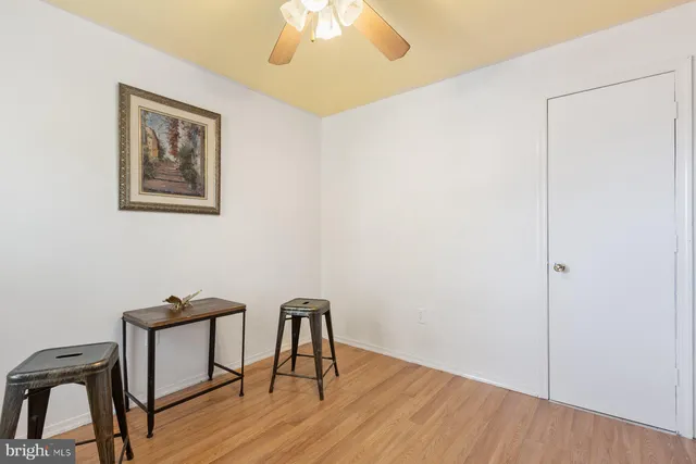 a view of a workspace with furniture and wooden floor
