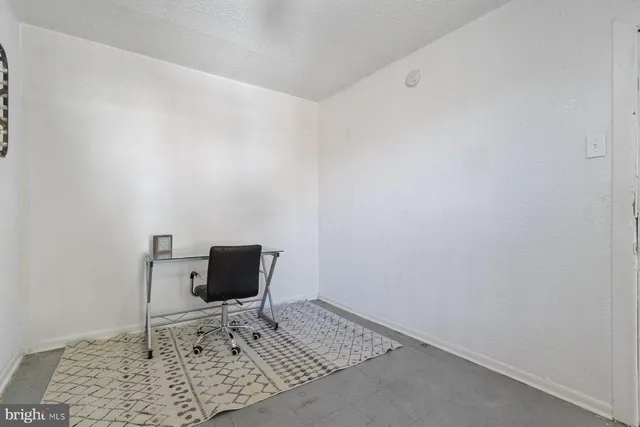 an empty room with a table and chair