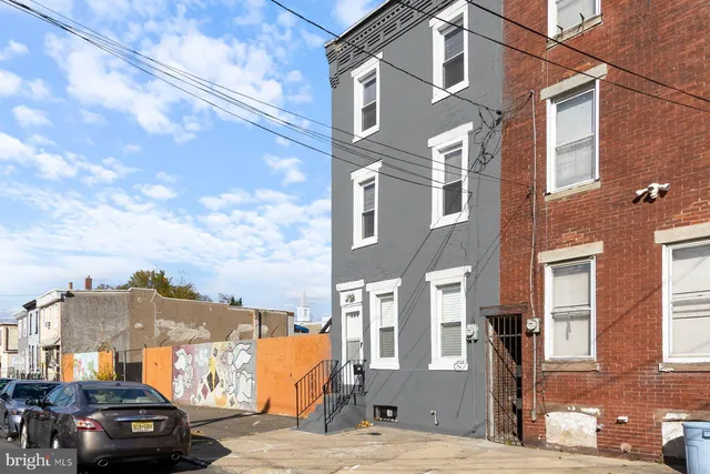 a front view of a residential apartment building with a yard