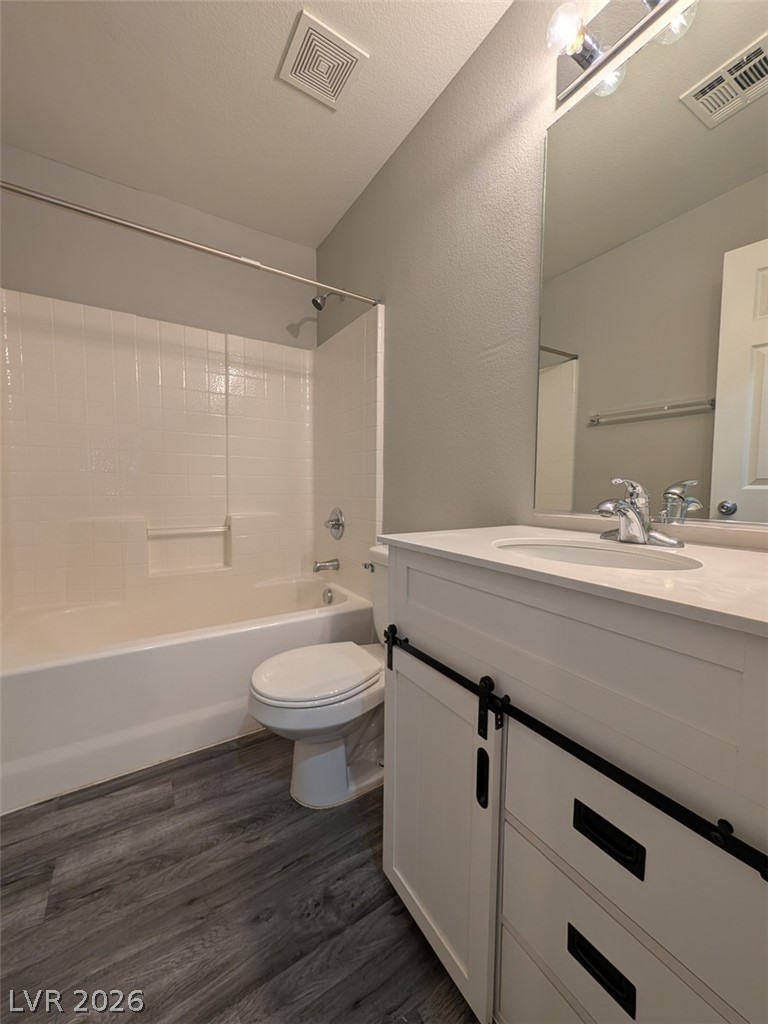 10308 Faustine Avenue Las Vegas, NV 89129 - Photo 7 of 28 A fresh bathroom presents a crisp white vanity and modern barn-style hardware.