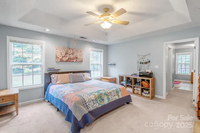 a room with a window and ceiling fan