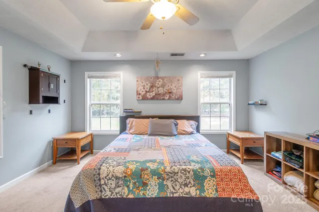 a bedroom with a bed and a chandelier