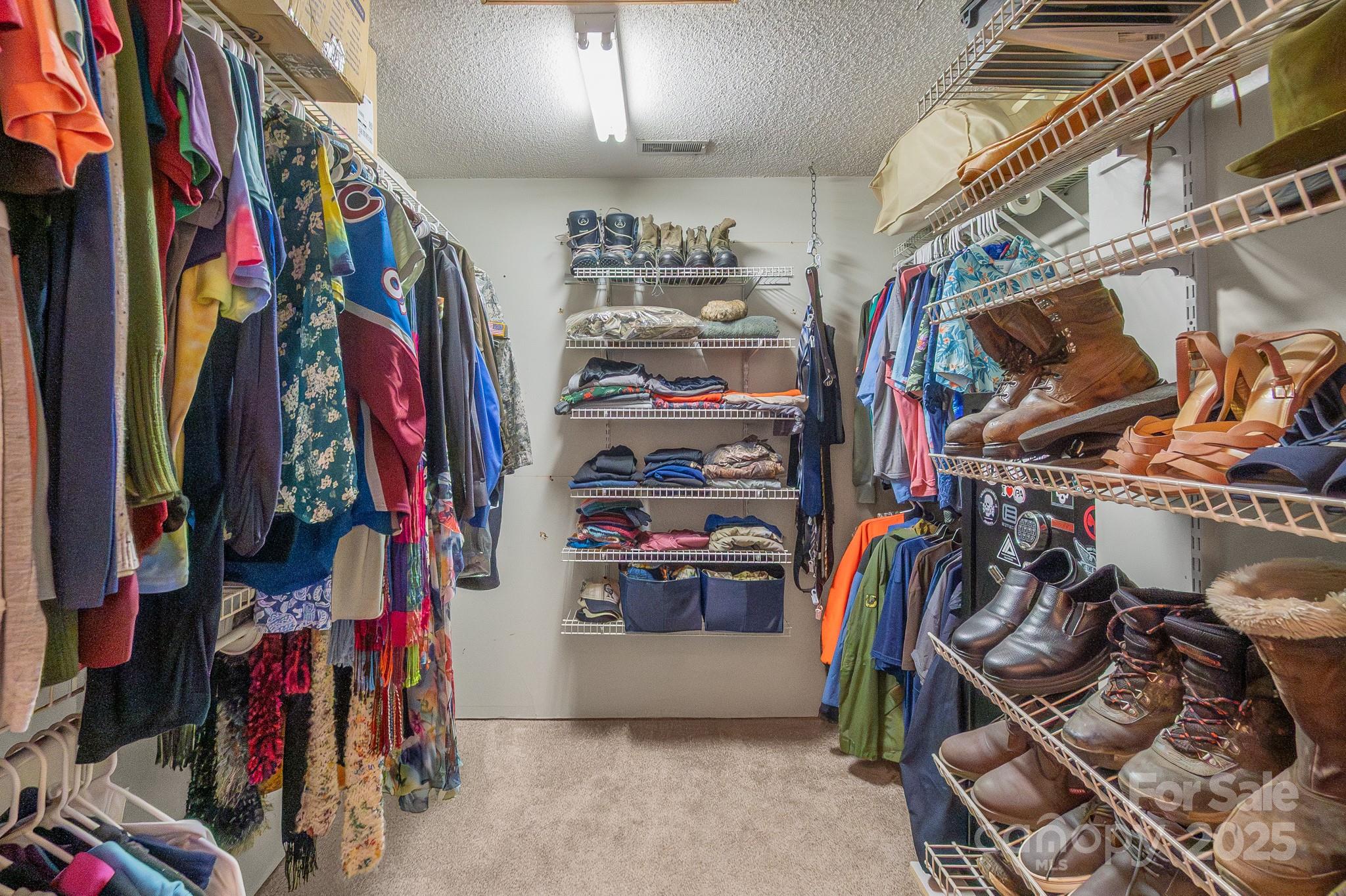 443 State Rd S-28-101 Elgin, SC 29045 - Photo 17 of 45 a view of walk in closet with clothes