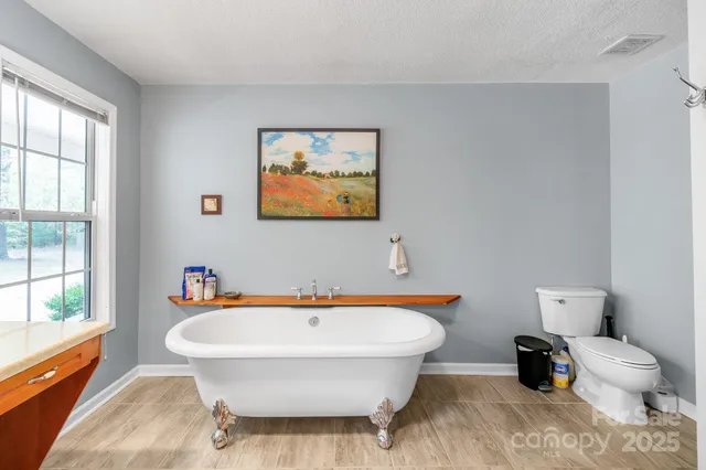 a view of a house with a yard and potted plants