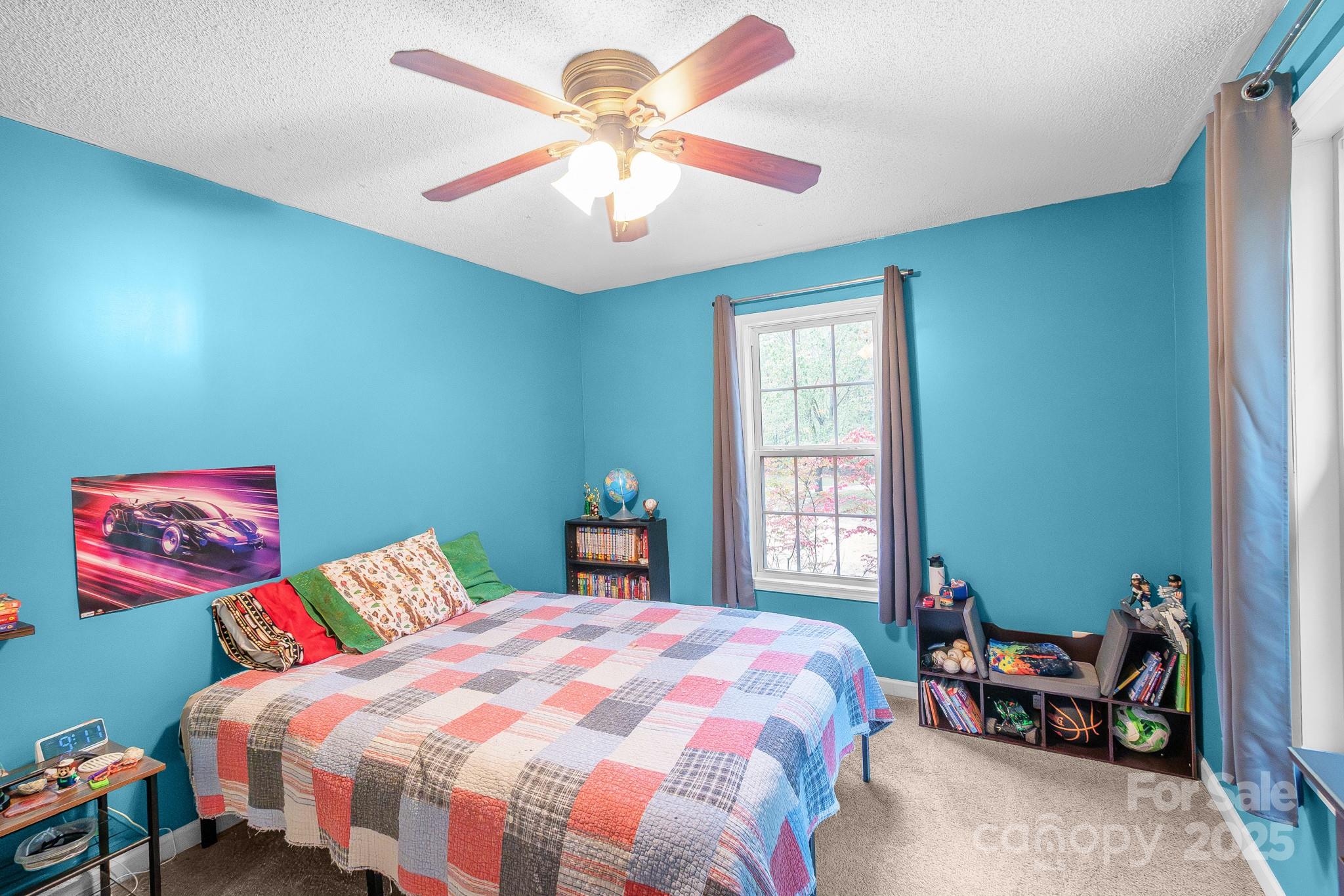443 State Rd S-28-101 Elgin, SC 29045 - Photo 22 of 45 a bedroom with a bed and a chandelier