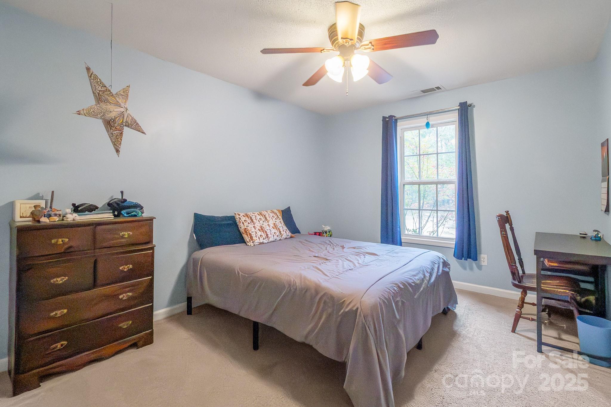 443 State Rd S-28-101 Elgin, SC 29045 - Photo 23 of 45 a bedroom with a bed and a chandelier