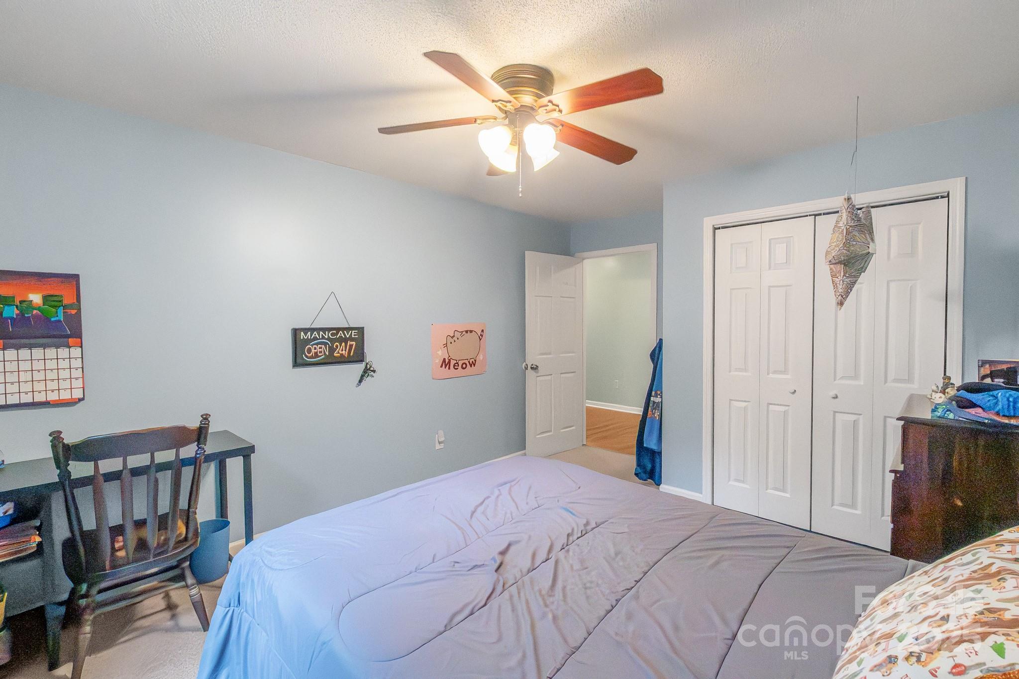 443 State Rd S-28-101 Elgin, SC 29045 - Photo 24 of 45 a bedroom with a bed and a chandelier