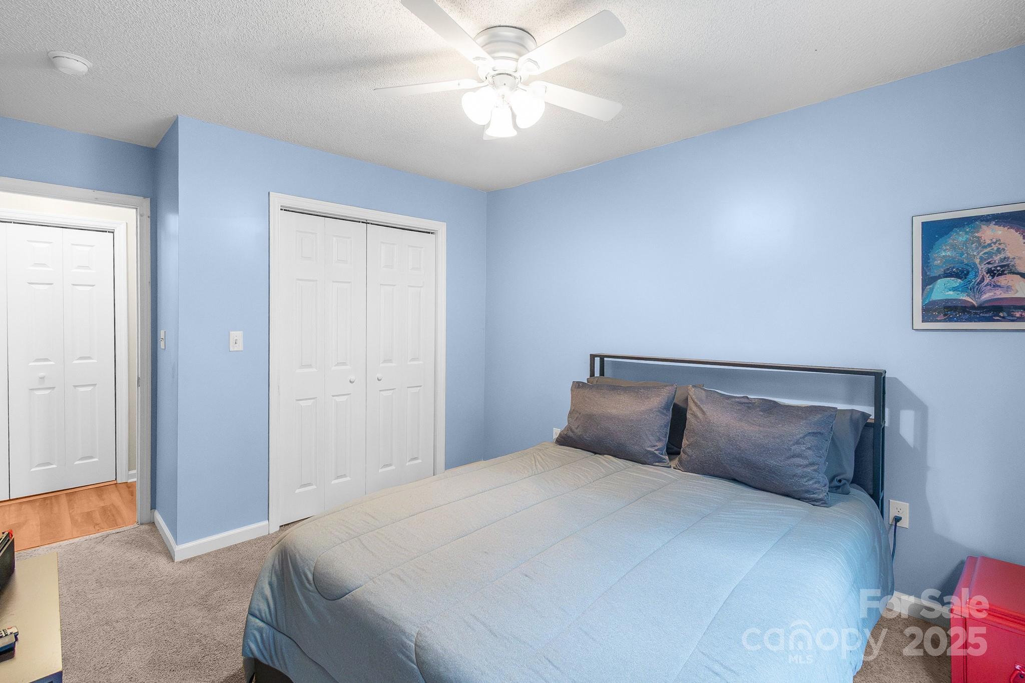 443 State Rd S-28-101 Elgin, SC 29045 - Photo 27 of 45 a bedroom with a bed and a chandelier